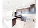 Modern kitchen with stainless steel appliances, granite countertops, tile backsplash, and ample cabinet space at 398 Citrus Isle Loop, Davenport, FL 33837