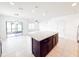 Bright kitchen featuring an island with granite countertop, and an open layout to living areas at 398 Citrus Isle Loop, Davenport, FL 33837