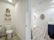 Bright bathroom with a toilet, tiled shower and double sink vanity, and round decorative shelves at 3980 Gadwall Pl, Leesburg, FL 34748