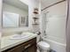Bright bathroom features a shower over tub and vanity with stylish decor and ample shelving at 3980 Gadwall Pl, Leesburg, FL 34748