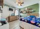 Bedroom featuring light green walls, a dresser, wall decor, and a ceiling fan at 3980 Gadwall Pl, Leesburg, FL 34748