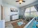 Bright Bedroom featuring a crib, changing table, playful rug, and natural light from the window at 3980 Gadwall Pl, Leesburg, FL 34748