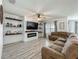 Comfortable living room with ceiling fan, electric fireplace, and custom shiplap shelving at 3980 Gadwall Pl, Leesburg, FL 34748