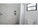 Modern bathroom shower showcasing marble tile and niche shelving at 411 Meadowood Blvd, Fern Park, FL 32730