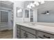 Bathroom vanity featuring gray cabinets, white countertop, and modern lighting at 411 Meadowood Blvd, Fern Park, FL 32730