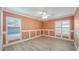 Bedroom with decorative trim, two windows with modern shutters, and ceiling fan at 411 Meadowood Blvd, Fern Park, FL 32730