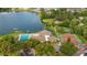 Community aerial view featuring clubhouse, pool, sport courts, playground, and lakefront access at 411 Meadowood Blvd, Fern Park, FL 32730