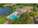 Aerial view of community clubhouse, pool, sports courts, and lakefront access at 411 Meadowood Blvd, Fern Park, FL 32730