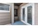 Close-up shot of the entryway featuring a wood door and storm door, framed by the neutral tones of the surrounding wall at 411 Meadowood Blvd, Fern Park, FL 32730