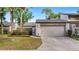 Charming townhouse with a one-car garage and a well-maintained front yard with a privacy hedge at 411 Meadowood Blvd, Fern Park, FL 32730
