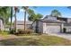 Home with a single car garage, well manicured garden and shade trees at 411 Meadowood Blvd, Fern Park, FL 32730