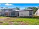 Charming home featuring an exterior of neutral tones, complimented by well-maintained landscaping and bright blue skies at 411 Meadowood Blvd, Fern Park, FL 32730