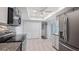 Modern kitchen with stainless steel appliances, granite countertops, light gray cabinets, and eat-in space at 411 Meadowood Blvd, Fern Park, FL 32730