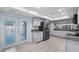 Bright kitchen with stainless steel appliances, gray cabinets, granite countertops, and french doors to patio at 411 Meadowood Blvd, Fern Park, FL 32730