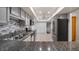 Well-lit kitchen with stainless steel appliances, gray cabinets, granite countertops, and tiled flooring at 411 Meadowood Blvd, Fern Park, FL 32730