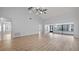 Open-concept living area with wood floors, neutral paint, and natural light at 411 Meadowood Blvd, Fern Park, FL 32730
