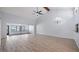 Expansive living room with vaulted ceilings, lots of natural light, modern ceiling fan, and wood-look flooring at 411 Meadowood Blvd, Fern Park, FL 32730