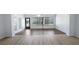 Open-concept living area featuring wood-look floors and a wall of windows at 411 Meadowood Blvd, Fern Park, FL 32730