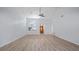 Spacious, airy living room featuring wood-look floors, vaulted ceilings, modern ceiling fan, and lots of natural light at 411 Meadowood Blvd, Fern Park, FL 32730