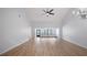 Open concept living room boasting spacious layout, vaulted ceilings, and wood floors at 411 Meadowood Blvd, Fern Park, FL 32730