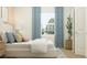 Relaxing bedroom with large window, plant, neutral decor and cozy furnishings offers a peaceful retreat at 4343 Curacao Pl, Kissimmee, FL 34758