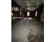 Interior view of a distressed property, revealing exposed wall studs and a ceiling fan at 509 Lemon St, Auburndale, FL 33823