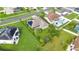 Aerial view of a single-Gathering home featuring lush green lawns, solar panels, and a sparkling backyard pool at 5203 Jasmine Trace Ln, Kissimmee, FL 34758