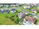 Aerial view of a single-Gathering home with lush green lawns, solar panels, and a sparkling backyard pool at 5203 Jasmine Trace Ln, Kissimmee, FL 34758
