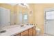 Functional bathroom featuring a vanity, toilet, and a large mirror with good lighting at 5203 Jasmine Trace Ln, Kissimmee, FL 34758