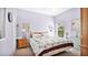 Calm purple bedroom featuring a double bed, a dresser, and bright window at 5203 Jasmine Trace Ln, Kissimmee, FL 34758