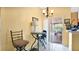 Cozy dining area featuring tile floors, a simple table setting, and a sliding glass door leading outdoors at 5203 Jasmine Trace Ln, Kissimmee, FL 34758