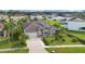 Aerial view of a single-Gathering home featuring a well-manicured lawn and solar panels at 5203 Jasmine Trace Ln, Kissimmee, FL 34758