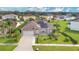 Aerial view of a single-Gathering home featuring a two-car garage, and manicured landscaping at 5203 Jasmine Trace Ln, Kissimmee, FL 34758