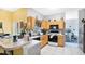 Functional kitchen with tile floors, light wood cabinets, and black appliances, offering ample counter space at 5203 Jasmine Trace Ln, Kissimmee, FL 34758