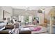 Inviting living room featuring tile floors, a ceiling fan, and a large arched window allowing natural light at 5203 Jasmine Trace Ln, Kissimmee, FL 34758