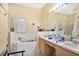 Bright main bathroom with double sinks, a garden tub, and a separate shower at 5203 Jasmine Trace Ln, Kissimmee, FL 34758