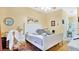 Bright main bedroom with a white bed frame, neutral walls, and ensuite bathroom at 5203 Jasmine Trace Ln, Kissimmee, FL 34758