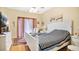 Bright main bedroom with a white bed frame, neutral walls, and a sliding glass door at 5203 Jasmine Trace Ln, Kissimmee, FL 34758