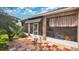 View of screened lanai with outdoor dining area, tile flooring and tropical garden views at 5203 Jasmine Trace Ln, Kissimmee, FL 34758