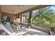 Spacious screened lanai featuring ceiling fans, tile flooring and views of lush, tropical foliage at 5203 Jasmine Trace Ln, Kissimmee, FL 34758