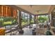 Bright sunroom featuring tile flooring, ceiling fans and an expansive outdoor view at 5203 Jasmine Trace Ln, Kissimmee, FL 34758