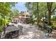 Spacious backyard with patio, outdoor seating, grill, and mature trees, perfect for entertaining at 556 Lake Ave, Altamonte Springs, FL 32701