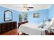 Bright bedroom with blue walls, hardwood floors, and ample natural light from the large window at 556 Lake Ave, Altamonte Springs, FL 32701
