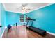Bright bedroom with hardwood floors, ceiling fan, and an exercise machine at 556 Lake Ave, Altamonte Springs, FL 32701
