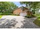 View of the home with a large driveway and three car garage at 556 Lake Ave, Altamonte Springs, FL 32701