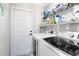 Clean laundry room with new front load washer and dryer and shelving at 556 Lake Ave, Altamonte Springs, FL 32701