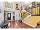 Welcoming foyer featuring beautiful staircase and hardwood floors at 556 Lake Ave, Altamonte Springs, FL 32701