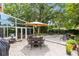 Expansive outdoor patio with seating, grill, and access to sunroom, surrounded by lush landscaping at 556 Lake Ave, Altamonte Springs, FL 32701