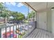 A view from a screened-in balcony overlooking the parking lot with some trees and another building at 6052 Westgate Dr # 204, Orlando, FL 32835