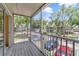 A screened in balcony that overlooks a parking lot with trees and other buildings in the background at 6052 Westgate Dr # 204, Orlando, FL 32835